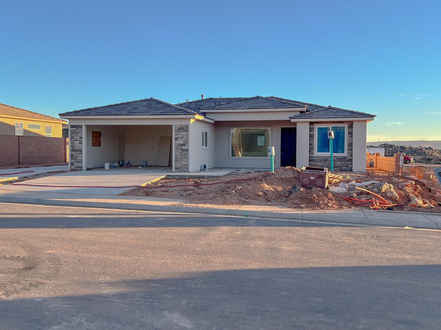 Gemstone Custom Homes - Construction to be complete 12/8/25. No HOA! This home features drought-tolerant professionally landscaped front and backyard with a covered patio. Master suite includes spacious walk-in closet and fully-tiled recessed walk-in shower with glass door. Two car garage is fully drywalled and painted! Quality GE appliances, Moen Plumbing fixtures, quartz countertops, spacious pantry, and classic stained hardwood cabinetry with soft-close hinges and under-cabinet lights. Woodgrain tile floors and gas fireplace in living room. Thirty-foot paved RV pad with full-hookups (sewer dump, 30-amp outlet, water connection) - Total width of the side yard with RV pad is approximately 25'! (water, 30-amp + sewer dump).