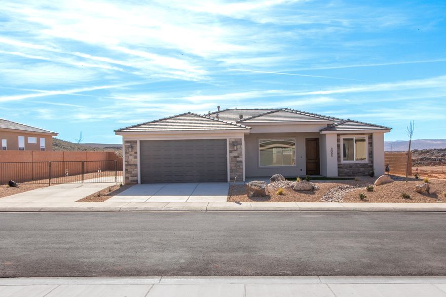 Gemstone Custom Homes - Construction to be complete 12/8/25. No HOA! This home features drought-tolerant professionally landscaped front and backyard with a covered patio. Master suite includes spacious walk-in closet and fully-tiled recessed walk-in shower with glass door. Two car garage is fully drywalled and painted! Quality GE appliances, Moen Plumbing fixtures, quartz countertops, spacious pantry, and classic stained hardwood cabinetry with soft-close hinges and under-cabinet lights. Woodgrain tile floors and gas fireplace in living room. Thirty-foot paved RV pad with full-hookups (sewer dump, 30-amp outlet, water connection) - Total width of the side yard with RV pad is approximately 25'! (water, 30-amp + sewer dump).