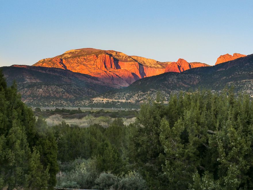 The views are incredible; the lot is secluded.  Perfect 5 acres with views in every direction. Zion Natl Park to the east, Pine Valley mountains to the west. Upgrades throughout. Beautiful, enclosed living area to enjoy the views of those red Rock cliffs of the Kolob Canyons.  Bring your horses to this equestrian community.  Bring your chickens, sheep, goats.  All those ATV's plenty of room in the 2-car garage or huge detached 2 car garage and workshops.