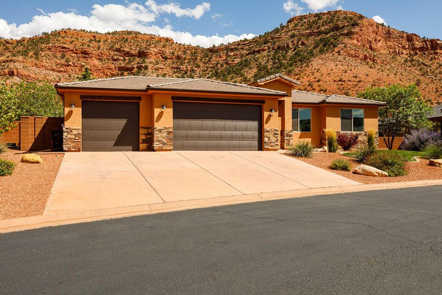 Live surrounded by breathtaking red rock canyon in this beautifully designed 3-bedroom, 2-bath home located in a vibrant and amenity-rich community. The open-concept living and kitchen area features striking beamed ceilings, a cozy fireplace, and tile flooring throughout the main spaces. The kitchen is perfect for entertaining w/a large center island and plenty of workspace, while the separate laundry room offers extra functionality with ample cabinetry and a utility sink. Both bathrooms are elegantly finished with custom tile and feature luxurious heated floors for year-round comfort. Step outside to enjoy the professionally landscaped yard, complete with mature fruit trees, a garden area, and a large covered patio ideal for entertaining or unwinding while soaking in the desert beauty. The oversized 3-car garage provides plenty of space for vehicles, gear, and recreational toys. Take full advantage of the community's incredible amenities, including a sparkling pool, relaxing hot tub, pickleball court, recreation room, and a fully equipped fitness center. Outdoor lovers will appreciate hiking access right from the community into the scenic red rock surroundings. buyer to verify all
