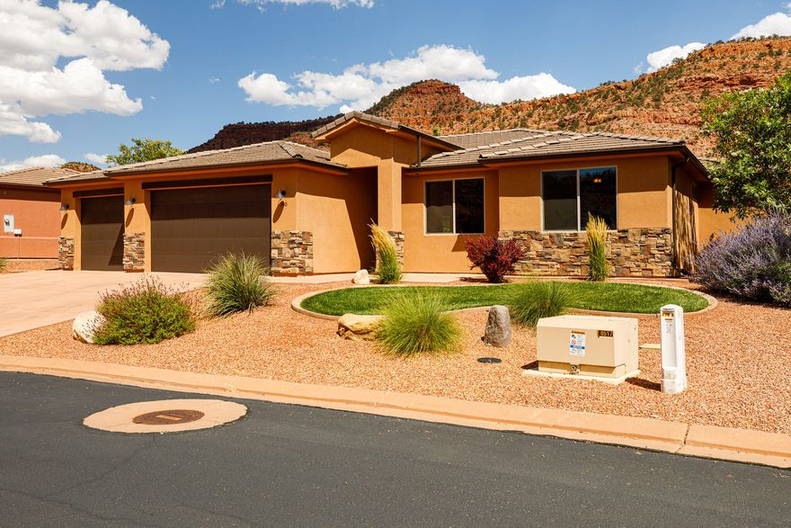 Live surrounded by breathtaking red rock canyon in this beautifully designed 3-bedroom, 2-bath home located in a vibrant and amenity-rich community. The open-concept living and kitchen area features striking beamed ceilings, a cozy fireplace, and tile flooring throughout the main spaces. The kitchen is perfect for entertaining w/a large center island and plenty of workspace, while the separate laundry room offers extra functionality with ample cabinetry and a utility sink. Both bathrooms are elegantly finished with custom tile and feature luxurious heated floors for year-round comfort. Step outside to enjoy the professionally landscaped yard, complete with mature fruit trees, a garden area, and a large covered patio ideal for entertaining or unwinding while soaking in the desert beauty. The oversized 3-car garage provides plenty of space for vehicles, gear, and recreational toys. Take full advantage of the community's incredible amenities, including a sparkling pool, relaxing hot tub, pickleball court, recreation room, and a fully equipped fitness center. Outdoor lovers will appreciate hiking access right from the community into the scenic red rock surroundings. buyer to verify all