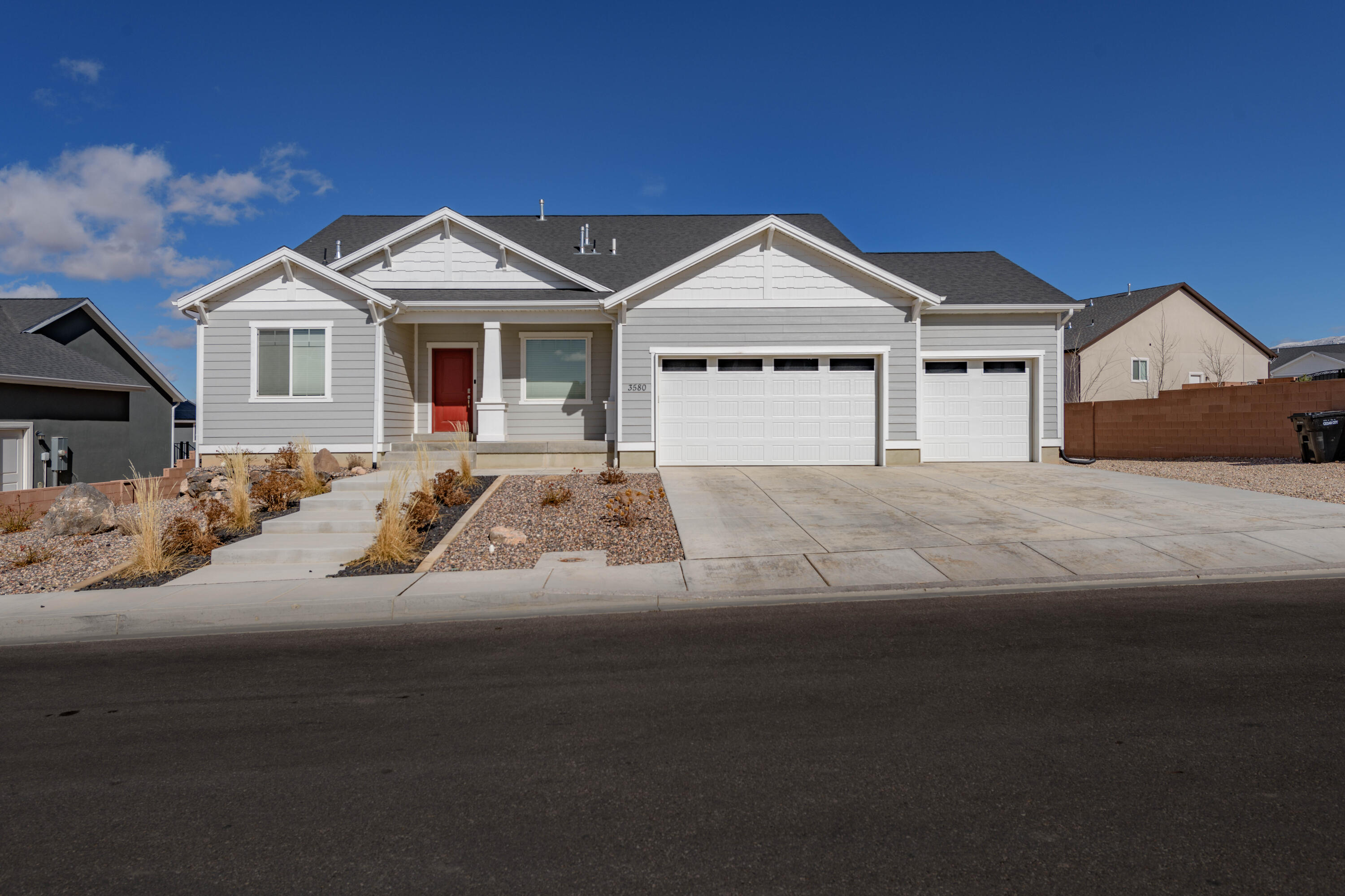 This home features a fully upgraded basement with a kitchen and en-suite bath. The basement is soundproofed with an insulated ceiling to help with noise for both up and downstairs and is equipped with split AC units in all rooms. The home features a 3-car garage, with room for toys and includes a Tesla charger. Out front there's room for an Rv with electric hook ups available. With exterior Ring camera security system, you can safely enjoy the two level back yard, deck and patio. Owner has newly added front steps, and hot tub wiring on the back patio. The backyard is landscaped with a block wall, natural rock wall, and a fire pit.