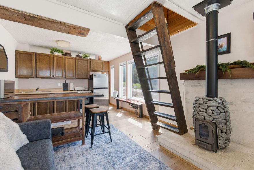 Discover the perfect mountain getaway in Brian Head! This charming studio loft condo is ideally located on the quieter end of town, just a short walk to both Chair 1 and Chair 8 for easy ski access in the winter, while also being steps from Bristlecone Pond and the park for summer recreation and events. As an end unit, this condo offers added privacy with only one shared wall and is filled with abundant natural light from its many windows. The loft creates additional sleeping space and offers exciting potential for expansion, with the opportunity to create nearly the same square footage upstairs as the main level for those looking to customize and add value. Whether you're searching for a personal mountain retreat, an investment property, or a nightly rental opportunity, this condo checks all the boxes. Even better, it features one of the lower HOA dues in all of Brian Head, helping keep ownership costs more affordable while still enjoying everything this four-season mountain destination has to offer.