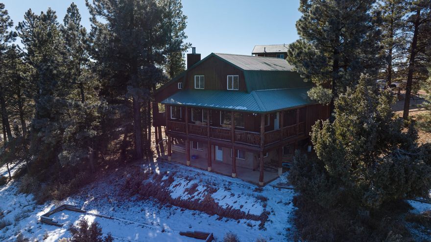 A proven 7-year short-term rental history with over 150 glowing reviews sets this exceptional mountain cabin apart. Designed to blend comfort, character, and generous space, this stunning retreat offers 7 bedrooms and 5 bathrooms—perfect for hosting large groups while still feeling warm and inviting. From the moment you arrive, expansive mountain views framed by wide, covered decks create an immediate sense of escape and relaxation.  The main-level primary suite allows for easy living and includes a private office and a bright, flexible loft space to suit your needs. The kitchen has been thoughtfully updated with new countertops, complemented by modern luxury vinyl flooring, while plush new carpet adds warmth throughout the home. Outdoors is where memories are made. Gather around Gather around the fire pit, enjoy a friendly game of horseshoes, or unwind in the hot tub under a canopy of stars. Expansive decks invite summer entertaining, while the wood-burning fireplace delivers the ultimate cozy winter retreat. Offered fully furnished with an attractive package, this cabin is truly turnkeyideal as a second home, high-performing investment, or both. Buyer to verify all information.