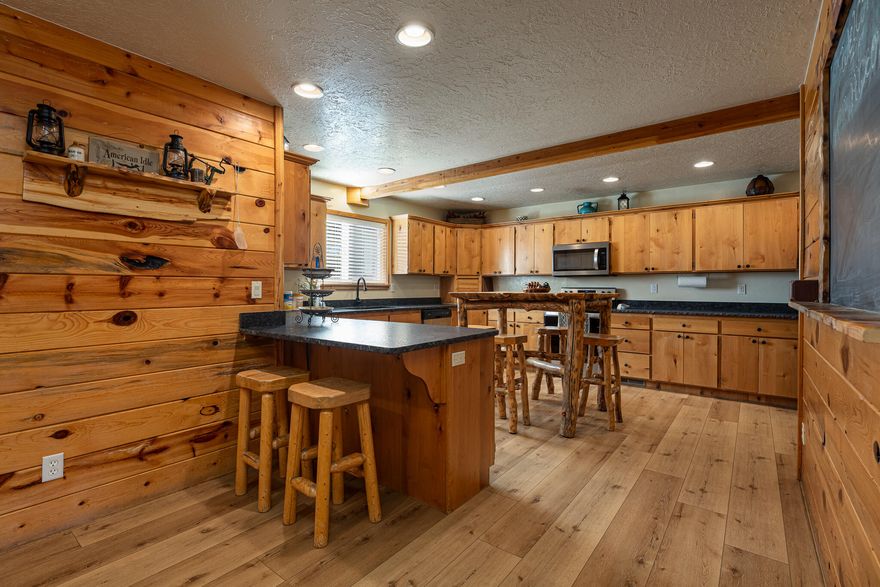 A proven 7-year short-term rental history with over 150 glowing reviews sets this exceptional mountain cabin apart. Designed to blend comfort, character, and generous space, this stunning retreat offers 7 bedrooms and 5 bathrooms—perfect for hosting large groups while still feeling warm and inviting. From the moment you arrive, expansive mountain views framed by wide, covered decks create an immediate sense of escape and relaxation.  The main-level primary suite allows for easy living and includes a private office and a bright, flexible loft space to suit your needs. The kitchen has been thoughtfully updated with new countertops, complemented by modern luxury vinyl flooring, while plush new carpet adds warmth throughout the home. Outdoors is where memories are made. Gather around Gather around the fire pit, enjoy a friendly game of horseshoes, or unwind in the hot tub under a canopy of stars. Expansive decks invite summer entertaining, while the wood-burning fireplace delivers the ultimate cozy winter retreat. Offered fully furnished with an attractive package, this cabin is truly turnkeyideal as a second home, high-performing investment, or both. Buyer to verify all information.