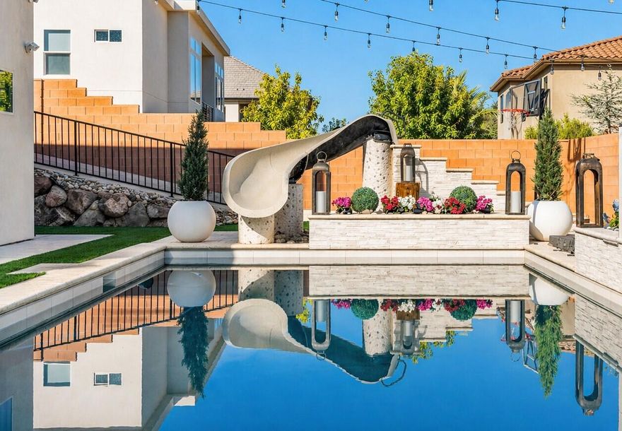 Step into elevated living with this beautifully upgraded home, thoughtfully designed to deliver luxury, comfort, and unforgettable indoor-outdoor entertaining, all situated on an expansive .29-acre lot in a desirable community. The true showstopper is the dream backyard, perfectly north-facing and built for year-round enjoyment with a stunning pool featuring a waterfall, slide, fire pit, kiddy pool with bubblers, separate hot tub, and pool cover. The outdoor experience is elevated even further with a fully equipped kitchen boasting gorgeous porcelain countertops, a built-in BBQ and pizza oven, plus a Terrace TV and Sonos sound system that creates an incredible atmosphere throughout the entire pool area. Inside, the main kitchen is equally impressive with a fully upgraded pantry and premium Thermador appliances, while the spacious primary suite offers a luxurious retreat complete with a custom Classy Closet system. Additional highlights include upgraded flooring and designer lighting throughout, a dedicated home theater room, and a fully finished basement with a second kitchen, laundry closet, and brand-new LVP flooring, perfect for guests or multi-generational living. The oversized 3-car garage is loaded with upgrades including epoxy floors, enhanced LED lighting, a built-in safe, and both electric and gas water heaters, all complemented by generous RV and toy parking for ultimate convenience. Buyer to verify all information, deemed reliable, however buyer to verify all info including utilities, rental restrictions, and HOA information if applicable.