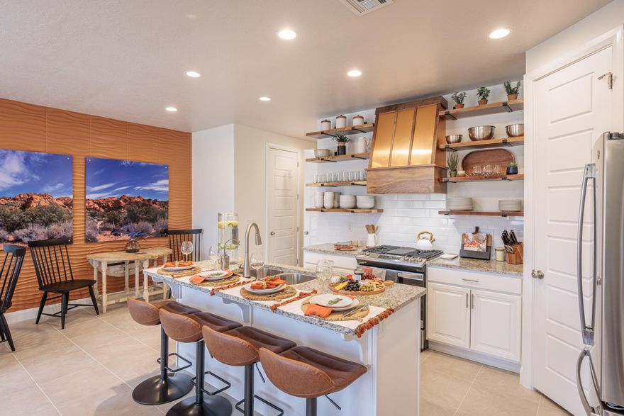 Discover this elevated property, showcasing a modern design with 3-bedroom, 4.5-bathrooms, conveniently positioned along the fairways of The Ledges golf community. The unit was professionally designed (interior design) by Kamari Interiors. This stunning home captures panoramic views of the red rocks, Snow Canyon, and manicured greens from nearly every window. The open-concept floor plan showcases high ceilings, designer finishes, and expansive glass doors. The kitchen features granite countertops, sleek cabinetry, stainless steel appliances, and a spacious island ideal for entertaining. Each bedroom offers its own en-suite bath for privacy and comfort, while the primary suite boasts a spa-like retreat complete with a walk-in shower, soaking tub, and private patio access. Upstairs, an oversized deck with a built-in fire pit provides the perfect place to unwind and take in the breathtaking sunsets over the desert landscape. Located within The Escapes at The Ledges, residents enjoy access to resort-style amenities including two outdoor pools, hot tubs and pickleball courts. This property is equally appealing as a primary home or a high-end vacation rental.