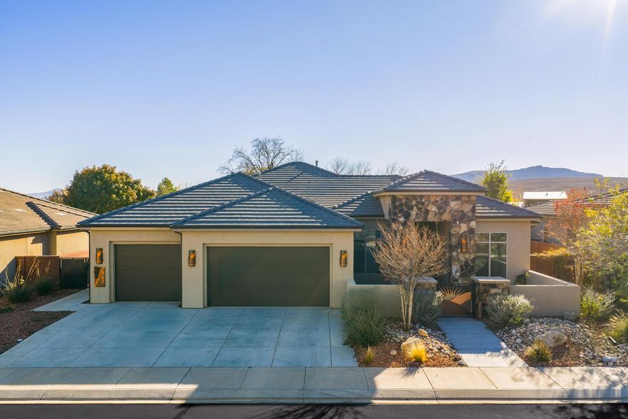 This upscale residence showcases exquisite custom copper accents throughout, creating a warm and sophisticated aesthetic. From the striking sunburst entry gate and outdoor sconces to the fireplace surround, range hood, beams, chandeliers, pendant lighting, and primary suite barn door, every detail reflects thoughtful craftsmanship and timeless design. Expansive picture windows frame unobstructed, breathtaking views of Red Mountain while filling the home with natural light. The open, entertainer-friendly layout is complemented by elegant quartz countertops and seamless indoor-outdoor living. Step into a quiet, private backyard complete with a Lifetime storage shed-perfect for relaxing or hosting gatherings. Ideally located just four miles from Tuacahn Amphitheatre and nestled near the stun
