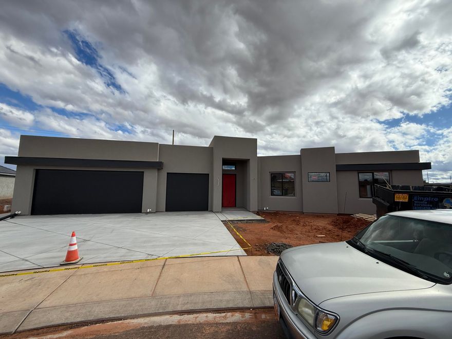 Come see this Jon Crockett masterpiece.  This home has a spa like bath in the owner's suite and Jr suite close by for the aging parent or lucky teen. This home comes fully landscaped with a water feature and fire pit, not to mention a strategic roof deck to capture the beautiful red mountain and other scenic vistas, or to bask in the sun.  Add the quality craftsmanship throughout and this one is easy to love. Come by and take a look, but beware, you will likely fall in love.