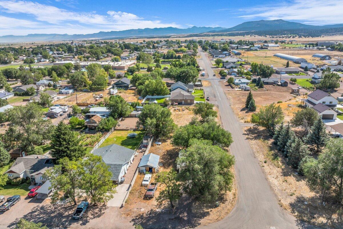 This charming home sits on a spacious .49-acre corner lot, offering plenty of room for relaxation and outdoor activities. Located in a desirable area with stunning mountain views and mature trees, it provides a peaceful, rural feel while still being close to amenities. The property is a great fixer-upper with tons of potential to make it your own. With a bit of TLC, this could become your dream home or a fantastic investment opportunity! Buyer to verify all info including utilities, rental restrictions, and HOA information if applicable.