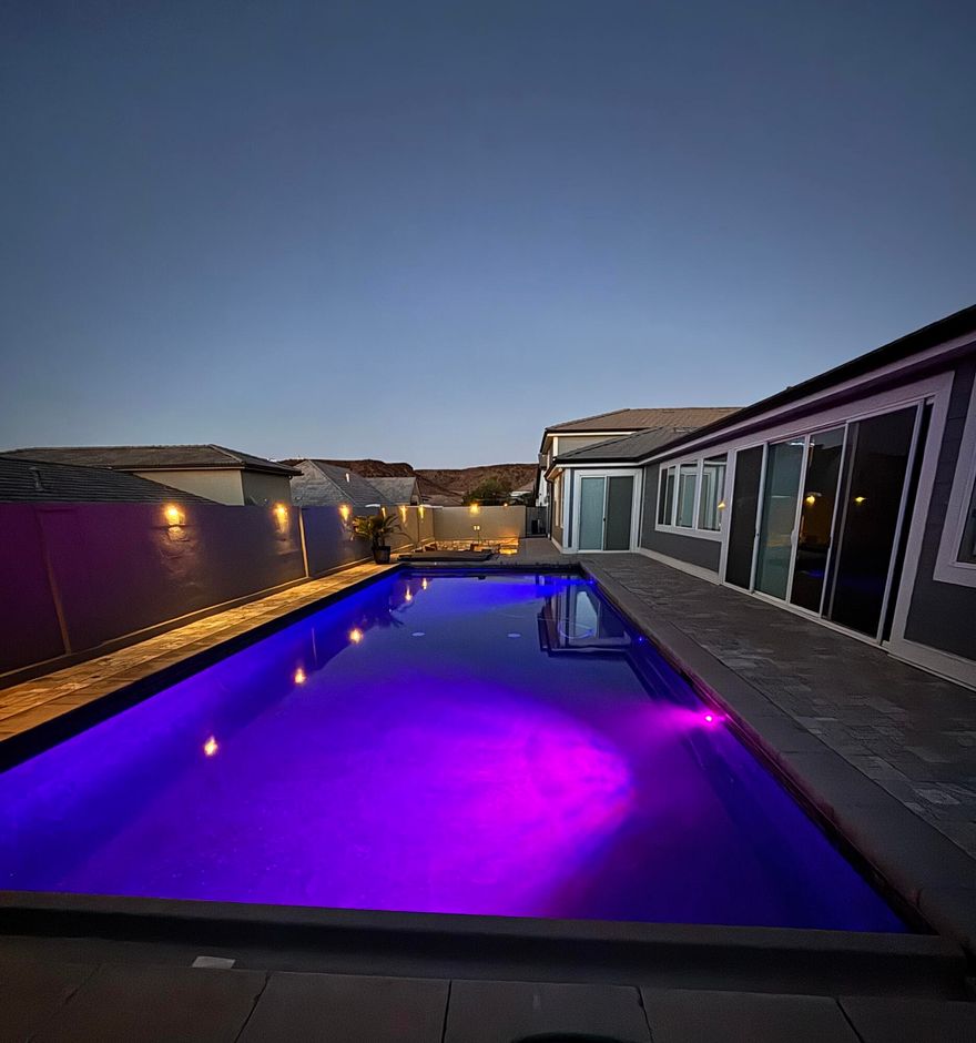 Just minutes from boating at Sand Hollow and world-class trail riding, this home delivers the ultimate vacation lifestyle. Enjoy a resort-inspired saltwater sport pool with spa, swim-up bar, two fire pits, and a luxe paver deck for outdoor entertaining. Inside you'll find 5 bedrooms (each with its own exterior entrance), 4 baths, and a bright modern kitchen. The oversized garage fits vehicles, a boat, UTVs, & adjacent full-length RV parking—perfect for all your toys. Thoughtfully designed for hosting guests or exploring rental potential*. Furniture package negotiable.
All information & square footage figures provided as a courtesy from appraisal, tax records, and plans. Buyer to verify all data. *Restrictions may apply to short-term rentals.