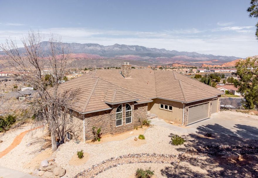 This home features 5 bedrooms, 3 bathrooms, and a 3-car garage across 3,780 sq ft. Elevated above Hurricane Valley, it offers incredible views of Pine Valley, Zion, Sky Mountain, and Cedar Mountain, framed perfectly through large kitchen windows. Enjoy a 1,000 sq ft wrap-around deck with unbeatable sunrise-to-sunset view the walk-out basement includes 2 bedrooms, a full bath, kitchenette, and a large family room. Ideal for a theater, gaming, or entertaining. There's also a safe room and a backyard ready for your vision--think pool or outdoor living space. Built in 1997, the home has been updated with a remodeled master bath, new carpet, refreshed front porch, and newer windows. Additional perks include a new water heater and a garage air compressor with pneumatic lines to the deck and hobby room.