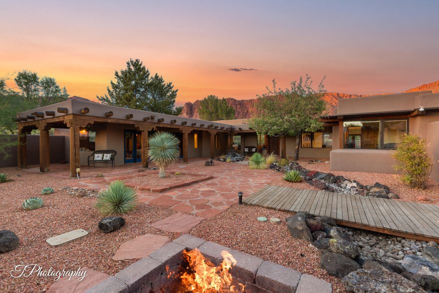 Set on 3.75 private acres with panoramic red-rock scenery, this one-of-a-kind Ivins home set in the unique desert community of Kayenta has direct access to the Hell's canyon from the back of the property. Head straight into Hellhole Canyon for hidden vistas and a seasonal waterfall when conditions are right! Inside, numerous updates showcase views from every angle, and don't miss the refreshed primary suite. The kitchen features a Bosch induction cooktop and generous prep space; an office with built-ins keeps work tidy. A standout third bedroom leans playful with a saloon vibe—king-size wall bed, bar taps, a pull-down projector screen, and its own bath. Enter through an enclosed courtyard with a flagstone patio and landscape stream, then spread out across multiple outdoor sitting areas and a back patio positioned for those waterfall moments. A true 3-car garage adds everyday utility, and the oversized lot offers room to explore future additions like a pool, casita, or extra garage (buyer to verify). Just a short walk from Kayenta's arts, shops, and dining. Optional membership available for community pools, pickleball, and tennis. Furniture package available. Ask for details. 
Minutes from Black Desert Golf Resort, Snow Canyon State Park and Tuacahn Amphitheatre.