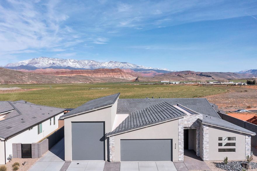 Stunning views!  Wake up to breathtaking views in this brand new 3-bedroom home designed to make the most of its stunning surroundings. From the moment you step into the living room, you're greeted by expansive windows that frame the landscape like a work of art. Whether it's morning coffee as the sun rises or winding down at sunset, the view becomes part of your daily routine. Beyond the views, this home features a spacious layout with comfort and functionality in mind. The large 59' deep RV garage provides ample room not just for vehicles, but also for tools, hobbies, and all your recreational toys.  This home isn't just a place to live -- it's a place to relax, entertain, and truly enjoy the beauty right outside your window with quick access to Sand Hollow for boating, golfing or UTV trail riding.