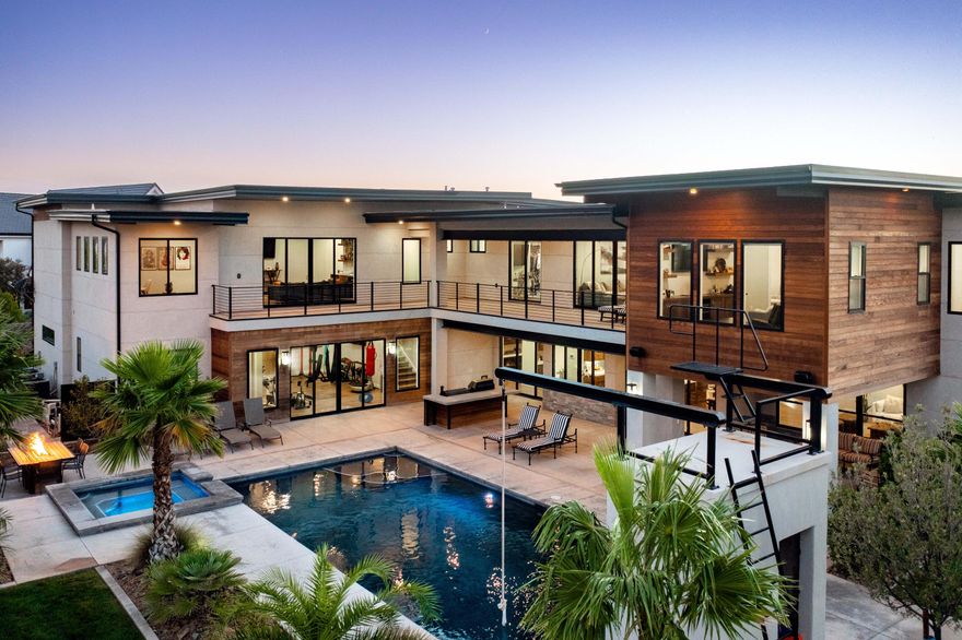 A Modern Family Retreat Designed for Entertaining and Connection
This architectural masterpiece sits on a half-acre in one of Southern Utah's most coveted neighborhoods. Thoughtfully designed for both intimate family moments and grand entertaining, this exceptional home offers six spacious en-suite bedrooms, a private office, piano/music room, and multiple living areas perfectly suited for work, wellness, and gathering.
Natural light floods the open-concept living area and chef's kitchen, creating an inviting heart of the home where family and friends naturally congregate. Premium amenities include a dedicated theater room, expansive home gym, and carefully curated details throughout that elevate everyday living.
Owner Agent Your Private Resort Awaits Step into your backyard oasis featuring a sparkling saltwater pool and hot tub, adventure-ready climbing wall, rope swing, and palm-lined landscaping. The unique roof design provides perfect evening shade, while the oversized deck creates an ideal setting for sunset dinners and outdoor entertaining.
Exceptional Storage and Workshop Space The oversized RV garage accommodates your boat-and-truck setup with room to spare, plus ample space for tools, toys, or a complete home workshop setup.
Move-In Ready Fresh interior paint and new carpet ensure this remarkable property is truly turnkey.

Showing Details Owner/Agent. Easy to show by appointment.