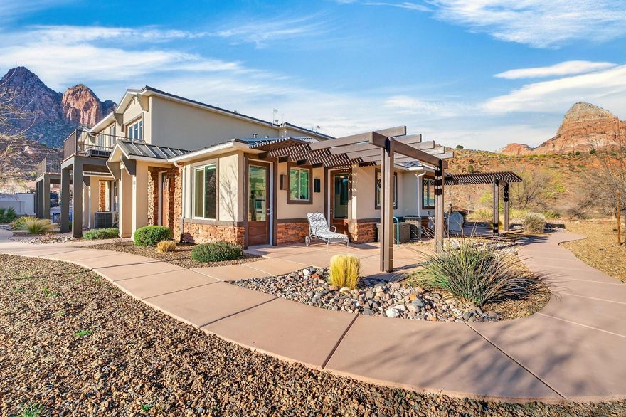 Welcome to your private Zion retreat where the rhythm of nature replaces the noise of the world. Tucked into a quiet corner of Springdale, this beautifully designed 1-bedroom, 1-bath condo offers an intimate escape beneath the towering red cliffs just moments from the entrance to Zion National Park.

Built in 2020 and thoughtfully upgraded, this 538 sq ft residence blends refined design with effortless functionality. Inside, fresh interior paint and beautifully refinished cabinetry create a warm, modern aesthetic. The living area features custom built-ins offering elegant shelving, a dedicated desk space, and abundant hidden storage perfect for maximizing comfort in this efficient layout.

The kitchen has been refreshed. Appliances include a microwave, stove/oven, refrigerator, dish washer, washer & dryer and disposal, while the home's water system has been enhanced with an advanced 11-stage drinking water filtration system by Oxygen Ozone and a water softener bringing everyday luxury to your mountain retreat.

Step outside and soak in the magic of the desert landscape. From the back porch, enjoy breathtaking, unobstructed views of The Watchman as the red rocks glow at sunrise and sunset. Wildlife often passes quietly through the neighborhood, making each day feel like a private nature documentary.

Despite the peaceful setting, you are only a half mile from the entrance to Zion National Park and just moments from the charming shops, art galleries, and restaurants in the heart of Springdale. Spend your mornings hiking iconic trails, afternoons exploring local cafés and boutiques, and evenings watching the canyon walls turn gold beneath the desert sky. Whether you are seeking a personal getaway, a low-maintenance basecamp for adventure, or a serene place to simply breathe in the beauty of southern Utah, this thoughtfully curated home delivers.

HOA includes: landscaping, exterior pest control, trash service, exterior insurance, and maintenance of common areas so you can spend more time enjoying Zion and less time worrying about upkeep.

Life here is simple, peaceful, and unforgettable exactly how living near Zion should feel.