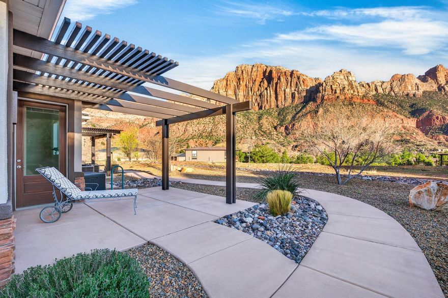 Welcome to your private Zion retreat where the rhythm of nature replaces the noise of the world. Tucked into a quiet corner of Springdale, this beautifully designed 1-bedroom, 1-bath condo offers an intimate escape beneath the towering red cliffs just moments from the entrance to Zion National Park.

Built in 2020 and thoughtfully upgraded, this 538 sq ft residence blends refined design with effortless functionality. Inside, fresh interior paint and beautifully refinished cabinetry create a warm, modern aesthetic. The living area features custom built-ins offering elegant shelving, a dedicated desk space, and abundant hidden storage perfect for maximizing comfort in this efficient layout.

The kitchen has been refreshed. Appliances include a microwave, stove/oven, refrigerator, dish washer, washer & dryer and disposal, while the home's water system has been enhanced with an advanced 11-stage drinking water filtration system by Oxygen Ozone and a water softener bringing everyday luxury to your mountain retreat.

Step outside and soak in the magic of the desert landscape. From the back porch, enjoy breathtaking, unobstructed views of The Watchman as the red rocks glow at sunrise and sunset. Wildlife often passes quietly through the neighborhood, making each day feel like a private nature documentary.

Despite the peaceful setting, you are only a half mile from the entrance to Zion National Park and just moments from the charming shops, art galleries, and restaurants in the heart of Springdale. Spend your mornings hiking iconic trails, afternoons exploring local cafés and boutiques, and evenings watching the canyon walls turn gold beneath the desert sky. Whether you are seeking a personal getaway, a low-maintenance basecamp for adventure, or a serene place to simply breathe in the beauty of southern Utah, this thoughtfully curated home delivers.

HOA includes: landscaping, exterior pest control, trash service, exterior insurance, and maintenance of common areas so you can spend more time enjoying Zion and less time worrying about upkeep.

Life here is simple, peaceful, and unforgettable exactly how living near Zion should feel.