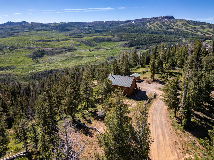 Discover breathtaking sunrises and sunsets from this beautiful log cabin in Brian Head. Located minutes away from Brian Head Resort. This meticulously crafted home features a wall of tinted windows in the living room and two spacious decks for enjoying views of the ski area, pink cliffs, and Tusher Mountain range. The kitchen boasts new granite countertops, modern appliances, and custom hickory cabinets. The main level includes a master suite with a remodeled shower and countertops. Upstairs offers a loft, an additional bedroom, and a bath, while downstairs features a large family room, another bedroom, laundry, and a water room with 1,500 gallons of storage. New toilets, a one-car garage, and an extra lot totaling 1.13 acres. Offered turn key for a seamless move-in!