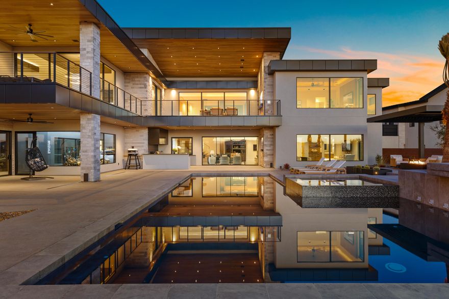 Welcome to the Jensen & Sons 2025 Parade Home.  A showcase of modern luxury, exceptional craftsmanship, and ultimate functionality. This remarkable estate spans 11,766 sq. ft., with 9,019 sq. ft. of livable space, thoughtfully designed to bring people together. With 16 garage spaces, including a massive 35x60 ft. RV garage/sports court, this home is perfect for car enthusiasts, adventurers, and entertainers alike. Every detail has been meticulously curated, and the home is being sold fully furnished with premium pieces from Bernhardt, Massoud, and other top-tier brands (see private remarks). Inside, five private en-suites provide comfort and privacy, while the show garage/game room adds a touch of fun and sophistication. The state-of-the-art Wolf/Sub-Zero appliances make entertaining effortless, complemented by luxury finishes from Kohler, Carrier, and Aria throughout. This home is not just stylishit's built for efficiency and security. A 21kW solar panel system with 40kW battery storage powers the estate, while four Carrier 26 SEER HVAC systems and temperature-controlled garages ensure year-round comfort. The vault, featuring 12-inch concrete walls and ceiling, provides an unparalleled level of security. Technology is seamlessly integrated with a $200K Crestron AV system, 21 audio zones, motion detectors, and a fully programmable, professionally designed layered lighting system. Luxury details elevate every space, from custom Aria air vents and kerfed drywall to stunning accent walls, including a breathtaking Venetian plaster feature in the primary bedroom. Step outside to expansive outdoor living spaces, where an outdoor kitchen with a hibachi-style built-in grill, a pass-through window, a sparkling pool and hot tub, and a cantilevered pergola create the perfect entertainment oasis. The floating paver pedestal deck system is both an artistic and engineering marvel, offering breathtaking views of Zion National Park and Southern Utah's stunning landscapes. Whether you're hosting gatherings, showcasing your collection, or indulging in a private retreat, this home is designed for those who demand luxury, versatility, and top-tier craftsmanship in every aspect of their living space. Experience the Jensen & Sons 2025 Parade Homewhere innovation meets elegance.
