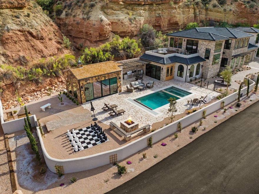 Experience elevated vineyard living at our beautiful 2025 Parade home, The Cottage at Mindira, a one-of-a-kind estate in the heart of Mindira Vineyard. This unique offering sits on a 1.38-acre parcel, PLUS it could be purchased with an additional 5.14-acre building lot (Lot #3) on the Virgin River.  With sweeping vineyard and cliffside views, the Cottage showcases Old-World charm with timeless stonework and modern luxury throughout. Enjoy a sparkling pool with vineyard views, a private wine tasting room, hidden poker den, and carriage house guest quarters. Lot #3 is a fully planted vineyard and offers endless potential, keep it in vines, build a second home on the elevated lot, and create your own private retreat! Located against the backdrop of Zion's cliffs, every sunset walk through the vines is unforgettable. Perfect for a primary residence, second home, or an event-ready estate, this property offers unmatched beauty and privacy.
This property includes The Cottage (560 Vineyard Road tax ID R-1304-A, 1.38 acres) and COULD include Lot #3 (R-1252-A, 5.14 acres), total acreage would be 6.52 acres if both are purchased and 1 acre foot of water, enough for two homes and 4 shares of irrigation will be included.