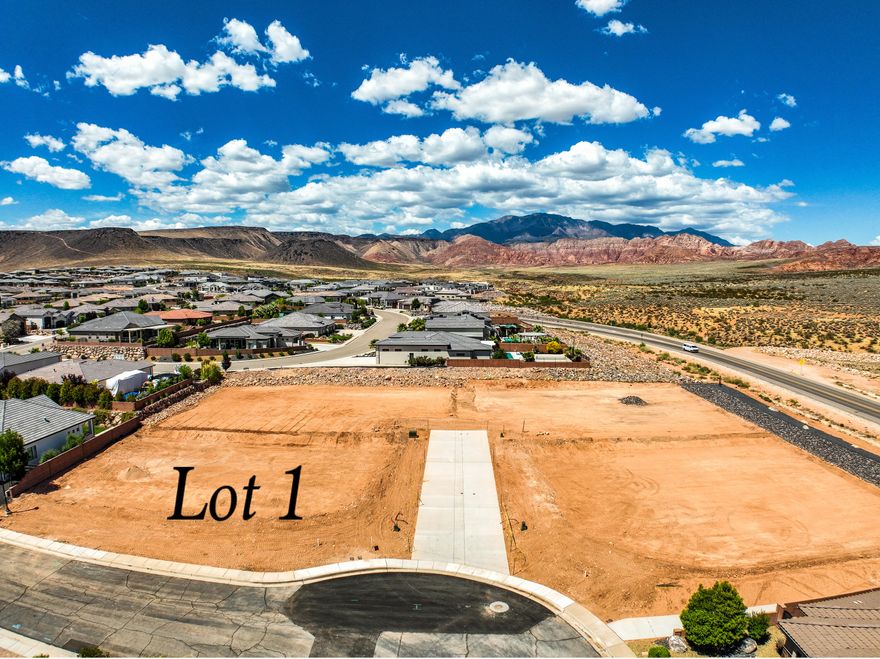 Exceptional opportunity to build in an exclusive new four-lot subdivision, ideally situated just off Washington Parkway and surrounded by established, upscale neighborhoods. These premium homesites offer convenient access to shopping, dining, recreation, and major travel routes, all while showcasing breathtaking views of the iconic red rock landscape. Generous lot sizes provide the perfect canvas for a custom home designed to fit your vision.