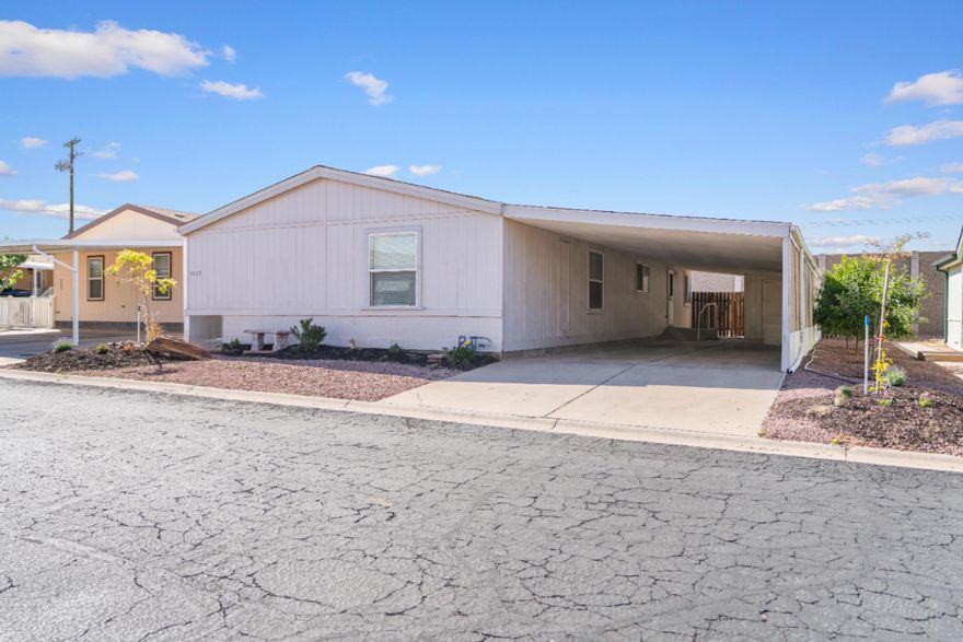 Located in the desirable Lava Bluff 55+ community, this thoughtfully remodeled 1,612 sq ft home offers upgraded construction, modern finishes, and a highly functional split-bedroom layout. Built with 2x6 exterior wall construction, upgraded insulation, and .625'' hospital-grade drywall, the home provides improved structural strength, sound reduction, and energy efficiency compared to typical 2x4 construction found in many homes in the community. The open kitchen and great room create a comfortable main living space, while the private primary suite sits on one end of the home with two additional bedrooms and a full bath on the opposite side for ideal guest privacy. Recent updates include Luxury Vinyl Plank flooring throughout, new kitchen cabinetry, fresh interior paint, and updated lighting. The kitchen features custom concrete countertops and a striking 36'' concrete farmhouse sink, while bathrooms include custom concrete countertops with integral sinks. Outside, enjoy a spacious 16' x 54' semi-enclosed carport and new landscaping with apple and peach trees. Conveniently located near St. George, Quail Creek, Sand Hollow, and Zion National Park.