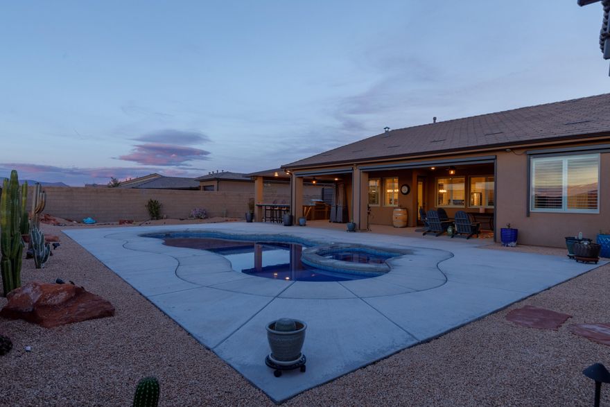 Wake up above the valley on one of Coral Canyon's rare rim lots--where privacy, panoramic views, and elevated outdoor living come together.

This 4 bed, 2.5 bath home is designed for both everyday comfort and effortless entertaining, with an open-concept layout that flows seamlessly to a resort-style backyard featuring a pool, spa, and outdoor kitchen--perfectly positioned to capture unobstructed views and unforgettable sunsets.

Inside, natural light fills the spacious living areas, complemented by a well-appointed kitchen with custom finishes and a thoughtfully designed split floor plan offering both privacy and functionality. A dedicated gym or flex space adds versatility to fit today's lifestyle.

Notable upgrades include electric shades, a whole-home water filtration system, and additional parking--enhancing both convenience and livability.

Step outside to your private backyard retreat or explore miles of scenic trails with direct access right from your doorstep.

Located just minutes from golf, dining, shopping, and everyday amenities, this meticulously maintained home offers a rare combination of location, lifestyle, and views--making it one of the most compelling opportunities in Coral Canyon.