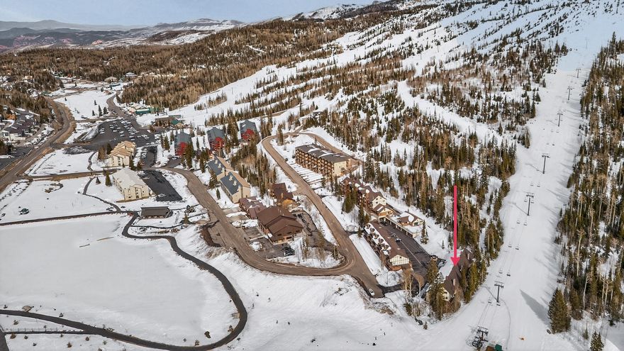 Discover this great condo in Evergreen Condos in Brian Head. Located directly behind Chair 8, this is a true ski-in/ski-out property with easy access to the slopes. This 2 bedroom, 2 bathroom condo with a loft offers 1,245 square feet of mountain living and features a cozy fireplace, perfect for relaxing after a day of skiing or outdoor adventure. The property works well as both a personal mountain retreat and an investment property and is currently being used for both. The unit also includes a one-car garage located below the condo for added convenience. The HOA provides snow removal and access to the community clubhouse, which features a game room, sauna, and additional laundry facilities. In recent years, the HOA completed several improvements, including a new roof, updated decks, and clubhouse renovations. Located in a fantastic spot in Brian Head with year-round recreation nearby, this property offers both convenience and mountain lifestyle.