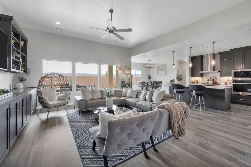 LOTS OF UPGRADES AND VIEWS OF THE SAND DUNES!! Welcome to this beautifully upgraded 4-bedroom, 3.5-bath home that perfectly blends modern design, functionality, and stunning sand hollow surroundings. Situated on a premium lot at the edge of the neighborhood, this property offers privacy and breathtaking views of the sand dunes right from your backyard. Inside, you'll find thoughtful upgrades throughout, including modern cabinetry in the kitchen, laundry room, and throughout. This home features an upgraded kitchen with quartz countertops, enhanced cabinetry, a designer hood, and high-end appliances--perfect for both everyday living and entertaining. The great room showcases custom-built cabinetry and shelving, adding both style and practicality.

The home continues to impress with upgraded flooring throughout, enhanced closet shelving, and a beautifully finished Jack-and-Jill bathroom featuring a walk-in shower upgrade. The mudroom includes custom-built lockers, offering an ideal drop zone for busy households.

Car enthusiasts and adventurers will love the extended RV garage with epoxy flooring, providing ample space for vehicles, toys, and storage. Additional features include a water softener system for added comfort and convenience.

Step outside to enjoy a low-maintenance backyard complete with turf, giving you a clean, green look year-round without the upkeep. Backing to the edge of the community, the yard offers extra privacy and sweeping views of the sand dunes--perfect for relaxing evenings or entertaining guests.

This home truly combines luxury upgrades with a prime location--don't miss the opportunity to make it yours!