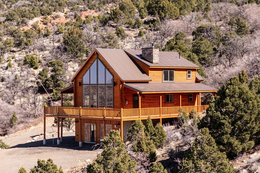 Brand-new lofted cabin in Cedar Highlands with panoramic views and year-round access! Built in 2024, this 3 bed, 3.5 bath home offers 2,496 sq ft on 1.30 acres. Features include luxury vinyl flooring, carpeted bedrooms, central air, natural gas heat, fully finished levels, walk-out basement, and covered deck. Kitchen includes range, microwave, dishwasher, and refrigerator. Located under an hour from skiing and within easy reach of Zion National Park. Ideal as a full-time home, second home, or mountain retreat.