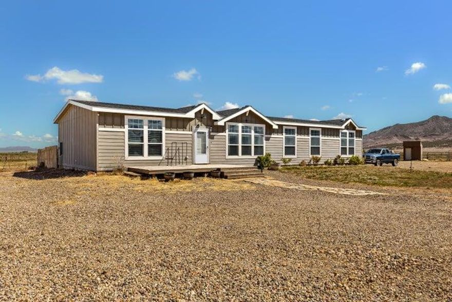 Spacious country living on 5.38 acres in Newcastle, UT! Built 2018, this 2,280 sq ft home w/3 bed, 2 bath plus office, mud room, large laundry, and two living spaces. Open-concept kitchen, dining, and living room feature vaulted ceilings, wood-burning fireplace, abundant cabinetry, and hidden pantry. New stove and dishwasher included. Vinyl/carpet flooring throughout. Private primary suite with dual vanity and walk-in shower. Central heat, three window cooling units. 300 ft well, septic, fiber optic internet, 0.50 ac-ft water right #71-5529 (priority 1943), and paved road access. Horse/cattle corrals, chicken coop, and two sheds included. RV hookups (power & septic). Zoned R-5 for flexible rural use, animals, and expansion. Enjoy mountain views east and valley views west. Dixie Power!