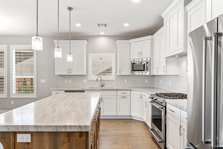 Exceptional opportunity to own in The Ledges of St. George. Beautiful one-owner home in The Ledges of St. George! This 3-bedroom, 2.5-bath residence offers 2,487 sq ft with a 2-car garage located in the Fairways which is a nightly rental approved community. The beautiful kitchen features quality finishes and opens seamlessly to the main living area, perfect for entertaining. Enjoy a north-facing backyard with summer shade, covered patio, and gas fire pit. South-facing front yard adds great natural light and curb appeal. Community amenities include pool, hot tub, pickleball courts, and fitness center. Close to city park, golf, hiking, and all St. George has to offer. Ideal as a primary home, second home, or investment!