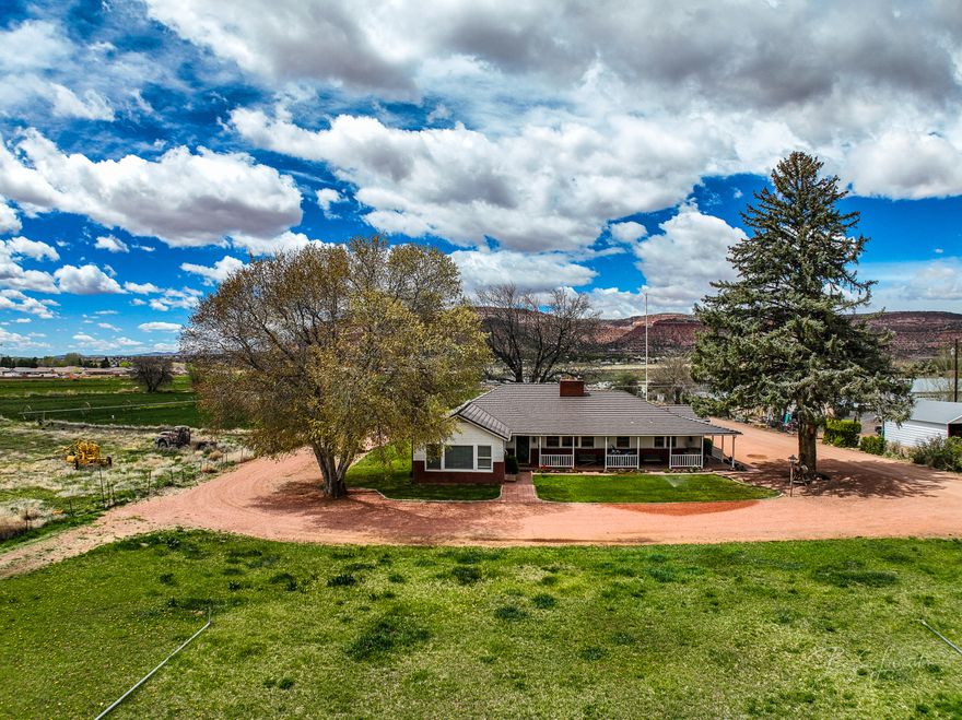 Seller Financing..Welcome to your slice of paradise nestled in the heart of Kanab, surrounded by stunning red rock landscapes. This 10.29-acre gentleman's ranch offers a unique blend of versatility with multiple zoning options, including commercial, multi-family, and residential. The property features a spacious 2,886 square foot vintage home boasting timeless charm, with 4 bedrooms and 3 bathrooms. Outside, a sprawling pasture, corrals, and irrigation system offer ample space for livestock and agricultural.

A substantial outbuilding at the rear of the property a perfect space for working on large farm equipment or storing equipment. Whether you're seeking a serene residential retreat or an entrepreneurial venture, this rare find offers endless. Listing agent is relative to seller in one of Utah's most picturesque settings.