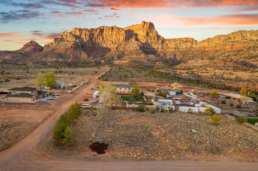 Don't miss this rare opportunity to own a flat, half-acre lot with unobstructed views of the breathtaking red cliffs that define this area. Perfectly positioned in a new and growing neighborhood, the property is surrounded by beautiful new homes and features mature trees along one side—offering both character and natural privacy.

All utilities are available to the lot line, making it easy to start building your dream home right away. With the incredible views, prime location, and ready-to-build setup, this lot offers the best of both convenience and natural beauty.
Seller will entertain any resonable offer.
Water meter on lot.
Water fee has been pd.  Balance of sewer hookup is $3000 plus $150 installation fee.  This equals estimated $14,000 savings to the Buyer.