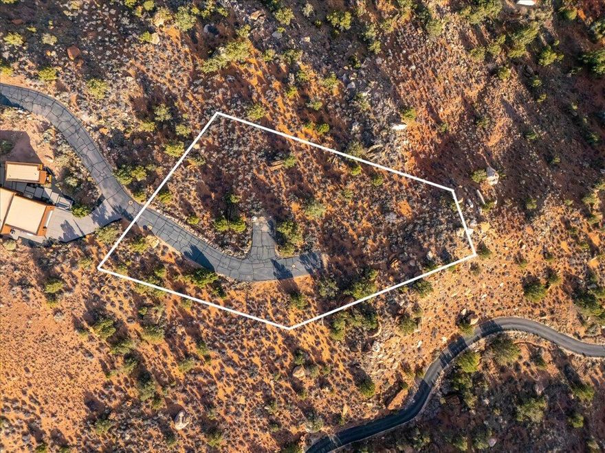 Walk in silence, savoring champagne beneath angelic sunsets on the edge of Zion. This is for the buyer who doesn't ask permission--someone who chooses what others simply can't have.

Tucked within a private, gated enclave of just six home sites, the Claret Cup subdivision offers rare seclusion and a true sense of arrival. A generous building envelope invites you to shape a home that captures the cliffs, the light, and the vast open space in a way that reflects your vision.

Whether bold and modern or understated and serene, this lot offers the freedom to create without compromise. Every vantage point reveals a different expression of Zion--morning shadows, evening color, and a stillness that feels entirely its own.