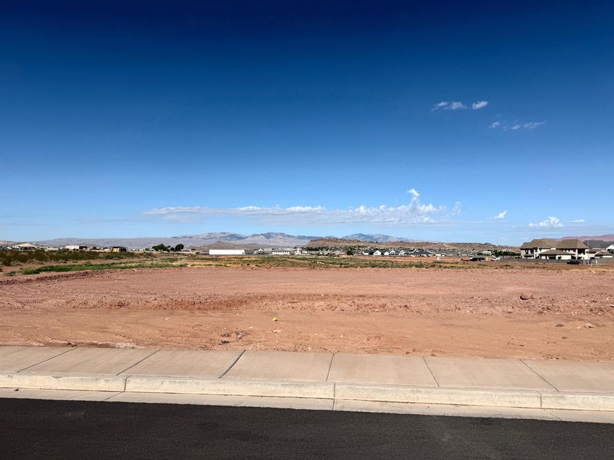 .25 acre lot that is elevated with no immediate backyard neighbor with views towards St. George. Located in North Rim Farms just 2 blocks from Crimson Cliffs High school. Use our experienced custom builder or bring your own.