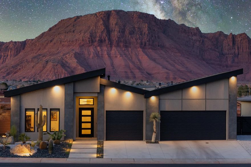 This modern luxury home boasts breathtaking Red Mountain views, perfectly capturing the natural beauty of the surrounding landscape. Located in close proximity to popular destinations like Black Desert Resort, Snow Canyon State Park and Tuachan Amphitheater. The chef's kitchen is a culinary haven featuring high end appliances, rich walnut cabinets and stunning quartz countertops. Additional features include motorized blinds, epoxy floors, remote controlled patio misters, wrought iron front door and impressive office area with glass doors. Large windows throughout the home frame the majestic views. Guest bedroom with private outside entrance offers flexibility and comfort for guests.  Expansive outdoor space for seamless indoor/outdoor living with covered patio and built in gas firepit.