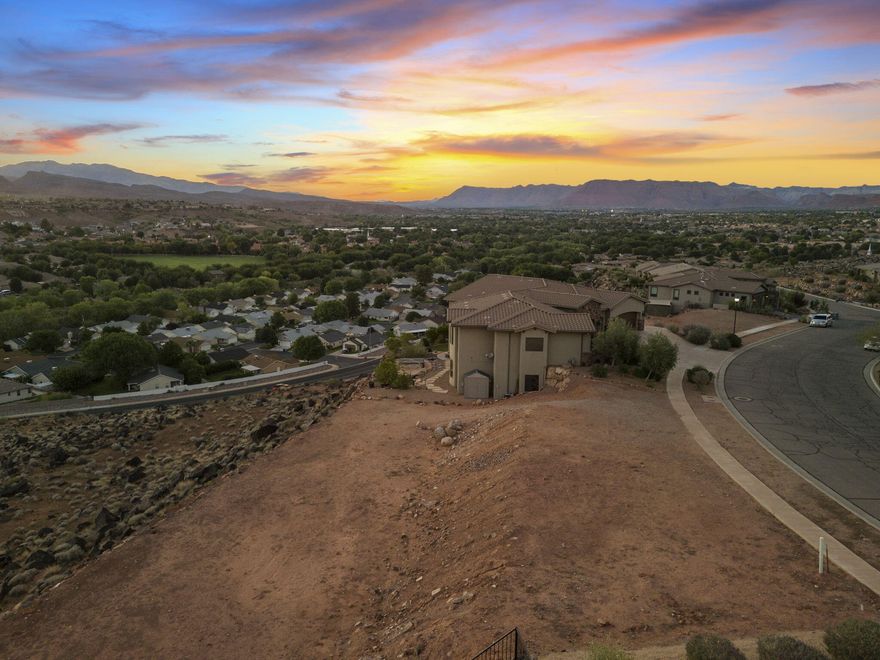 STUNNING VIEW LOT.! This lot is perfect for those looking to build their DREAM HOME on a spacious lot, spectacular views and NO HOA. This massive .40 acre lot includes all utilities to the property line at the street. The lot is located in an elevated community known as WHISPER RIDGE, which includes 180 degree unobstructed valley and mountain views. It's central location puts you minutes from Tech Ridge, Downtown, or quick access to I-15. Did I mention, VIEWS that most people would die to have. Come see for yourself!