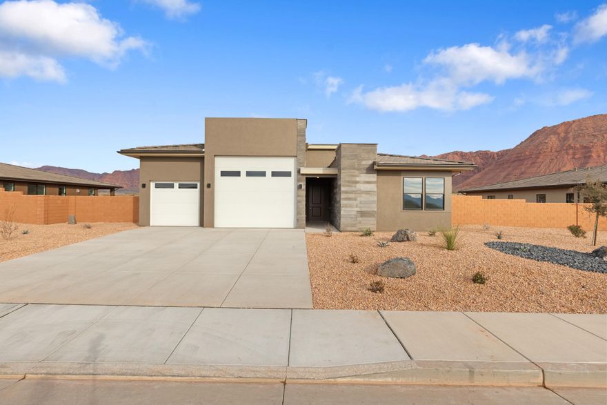 Interest rates as low as 3.999% available through our preferred lender. Must see views &  larger lots. Surrounded by beautiful mountain and desert scenery. Unity Park, Fire Lake at Ivins resort, and Keyanta art village are just around the corner. Tuacahn amphitheater, Snow Canyon State Park, and Black Desert, Golf Course and resort are all a short drive away. Included features: a welcoming covered entry; two secondary bedrooms; a shared full bath; a quiet study; a convenient powder room; a gourmet kitchen boasting a large island, a tile backsplash, 42'' upper cabinets, stainless-steel appliances and an ample walk-in pantry; an adjacent dining area overlooking a comfortable covered patio with multi-slide doors; a generous great room with contemporary fireplace and a central laundry area.