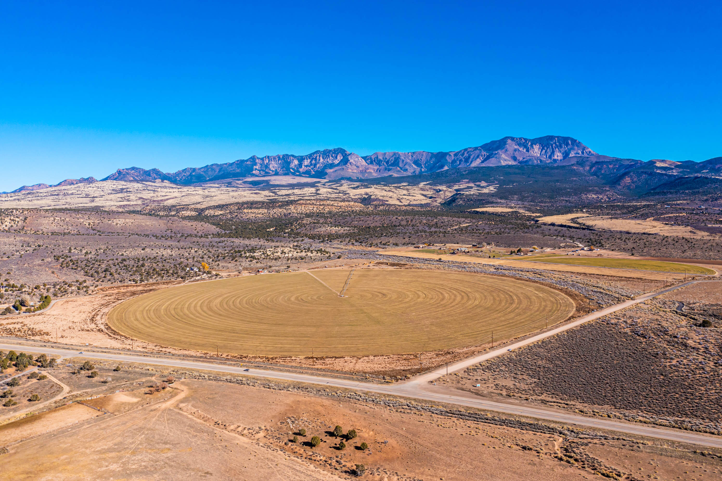 Amazing opportunity to own over 126 acres (plus 50 acre feet of water) of cultivated land just a short 8-10 minutes drive from Sunset BLVD in St. George. A straight shot up Highway 18 slightly past Diamond Valley and south of Dammeron Valley. BLM land largely to the north, and Snow Canyon State Park to the south and west just over the adjacent private property. Countless opportunities as this land offers highway frontage as well as peaceful acreage surrounded by large fields & BLM land. The land is currently unincorporated under the jurisdiction of Washington County. The power runs along H-18, but there is not public sewer, culinary water or natural gas as of yet; however, there are talks of extending public utilities from Winchester Hills/Ledges areas to Dammeron Valley which would cross right through this land. A potential great option would be commercial use along the highway, and then larger horse property lots behind the commercial. Neither one of these options is approved they are just ideas. *All information is deemed reliable but not guaranteed, buyer(s) to verify all.