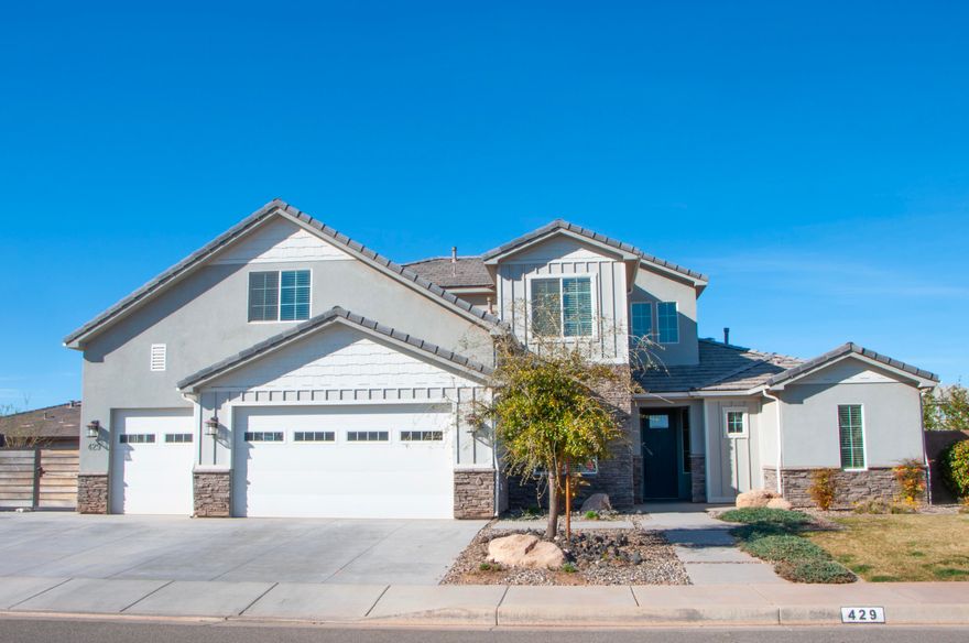 This beautifully finished home highlights an open-to-below family room with a 20' ceiling that fills the space with natural light and creates a stunning sense of openness. Thoughtful finish work throughout showcases quality craftsmanship and timeless design. The 6th bedroom could also be an office or additional room on the main level.  RV parking on the side of the home in addition to the epoxy finished 3 car garage allows for all of your parking needs. Additional family room upstairs is enclosed allowing for all the noise to be captured behind closed doors! Great location close to schools, airport, lakes, and all the great things St George has to offer!