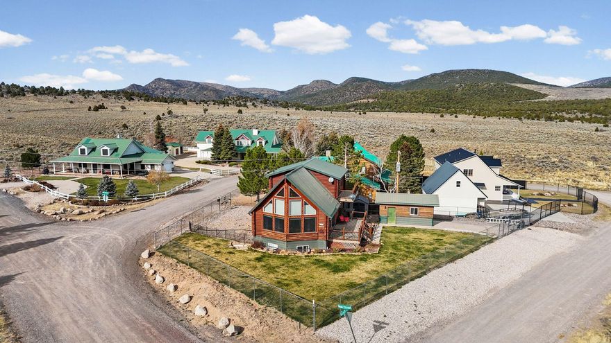 Two kitchens and a walk-out basement make this stunning A-frame log cabin as functional as it is beautiful! Completed in 2001, this 2,600+ sq.ft. retreat offers a spacious main-floor master suite, open living area with vaulted ceilings, and large windows showcasing mountain views. The upper loft features a private balcony, while the wraparound deck is perfect for relaxing or entertaining. Detached 1-car garage, storage shed, and plenty of parking. Whether you're looking for a full-time mountain home or a weekend escape, this Pine Valley gem delivers comfort, charm, and unbeatable scenery year-round.
