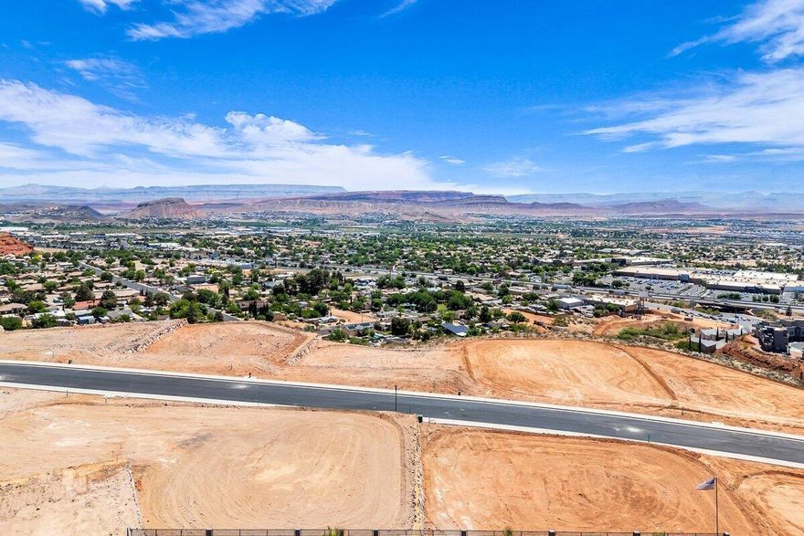 Interior view lot with exceptional views overlooking the city, mountains, Pine Valley, red rock mesas, Sand Hollow, and even Zion National Park! Best suited for a rambler floor plan, this lot is located in the final phase of Grand Heights, the highest elevated subdivision in St. George proper, nearly 500 feet higher than the rest of town, including Stone Cliff and Foremaster, offering unmatched views. Enjoy quick access to downtown, hiking and biking trails, and off-road adventures, plus you're just 15 minutes from two major fishing reservoirs and over half a dozen top-rated golf courses. With BLM land bordering the subdivision, you can ride bikes and ATVs straight from your doorstep. Numerous oversized lots are available with convenient highway access. Bring your own builder! Buyer is responsible for water impact fees. All construction requires prior review and approval by the architectural control committee. Buyer to verify all information, deemed reliable, however buyer to verify all info including utilities & ACC information if applicable.