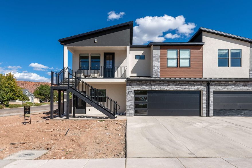 Brand new 5-bed, 4-bath townhome in Cedar City! Each level has its own full kitchen and laundry—ideal for multi-generational living, short-term rental, or house hacking. Common areas come fully furnished and kitchens are stocked with cookware, dishes, and essentials. Upstairs features 3 beds, 2 baths, open-concept living, a 65'' TV, covered patio, and front porch. Downstairs offers 2 beds, 2 baths, a full kitchen, laundry, and 55'' TV. Property will be fully landscaped with a brick  wall and a vinyl privacy fence between units. Purchase one side for $550K or both for double the opportunity!