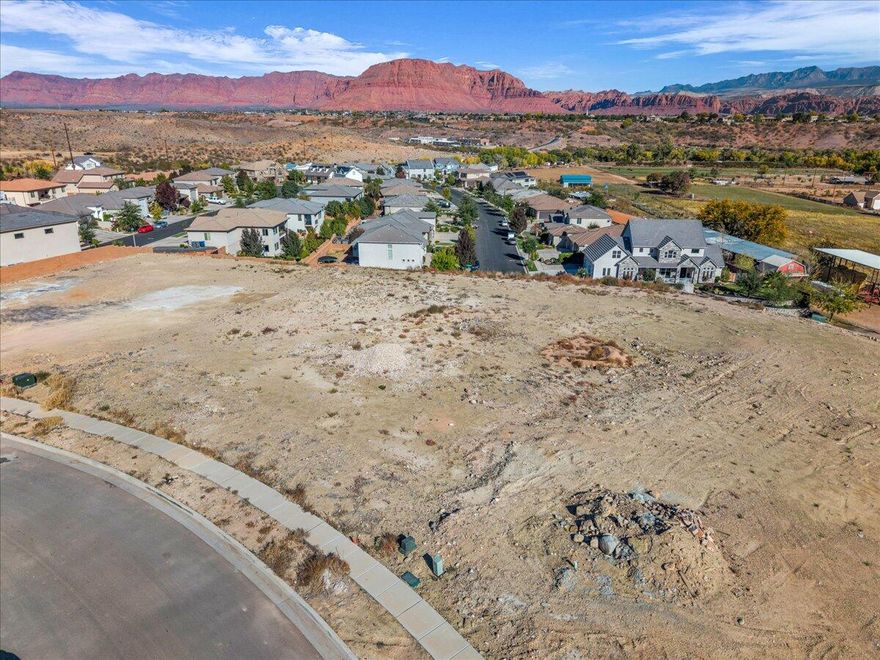 Build your dream home on this .77 acre pad ready lot offering panoramic views of Red Mountains, Pine Valley Mountain, Snow Canyon and surrounding valley. This flat, ready to build property provides the perfect setting for a luxury custom home! CC & R'S available. No HOA!!