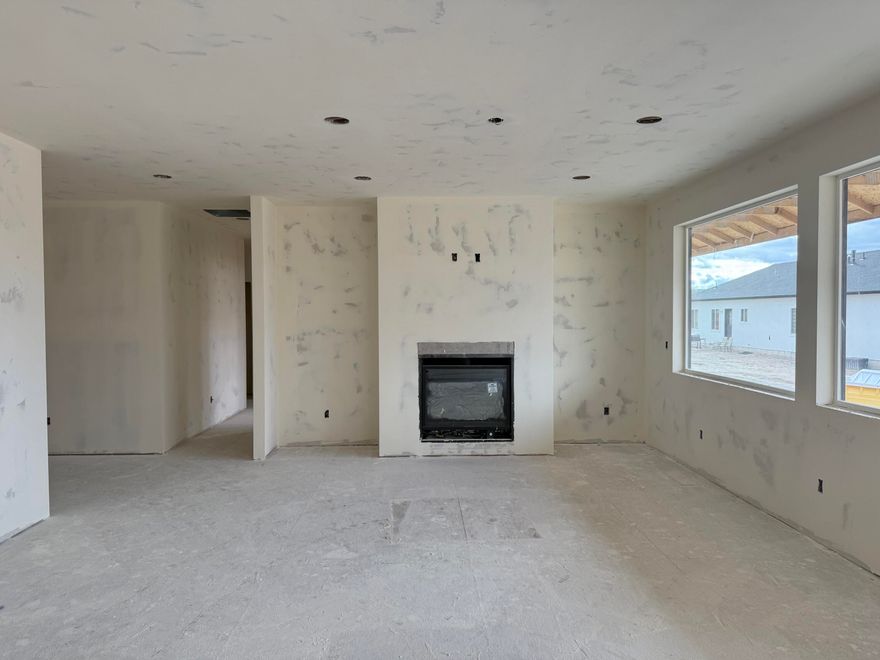 UNDER CONSTRUCTION — Estimated Completion: January 1, 2026

Welcome to this beautifully crafted custom home in the desirable Monroe Hot Springs Subdivision in Monroe, Utah. Nestled on a .28-acre corner lot with breathtaking mountain views, this single-level residence offers the perfect blend of comfort, style, and thoughtful design. Featuring 1,972 sq. ft. of well-planned living space, this 3-bedroom, 2-bathroom home showcases an open-concept layout with expansive windows that flood the living and kitchen areas with natural light. The heart of the home includes a custom-built fireplace with built-ins, a large kitchen island, and an oversized butler's pantry complete with a sink, custom cabinetry, and a built-in drinking fountain—ideal for both everyday use and entertaining. The luxurious primary suite offers generous space and direct access to the back patio, while the additional bedrooms provide comfort and flexibility for family, guests, or a home office. The tiled shower with a full-glass enclosure adds a touch of spa-like elegance to the primary bath. Whether you're sipping coffee on the front porch, enjoying the mountain scenery, or hosting gatherings in your designer kitchen, this home is built to impressinside and out.