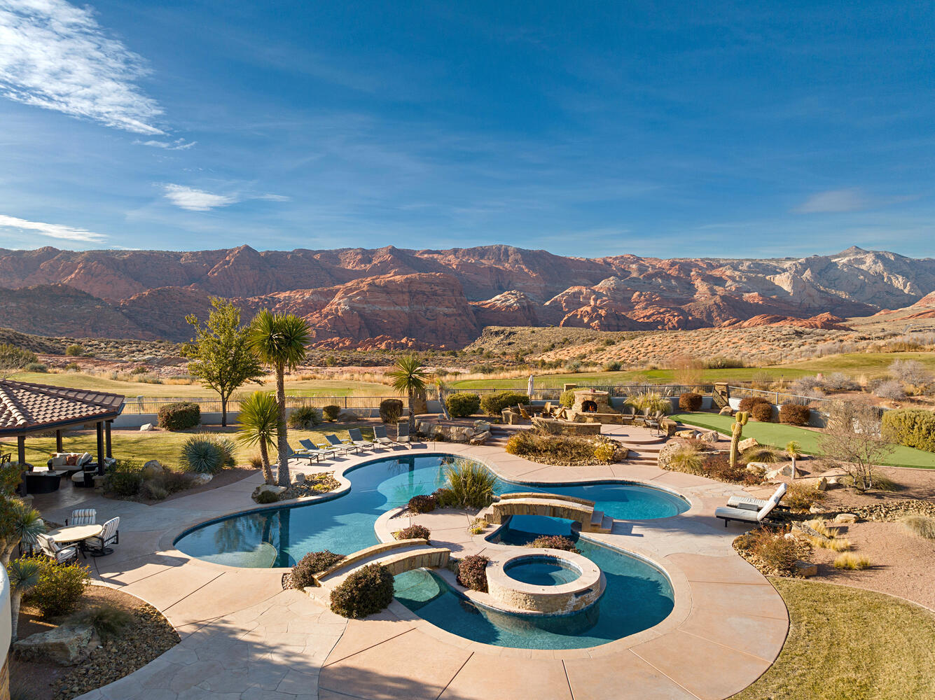 Welcome to 2110 Long Sky Dr, a private sanctuary of refined living, secured behind its own private access gates. This exceptional estate captures the beauty and grandeur of Southern Utah, offering both tranquility and sophistication. Perched on 1.2 pristine acres, it showcases breathtaking panoramic views that will make you feel like you are on top of the world. Thoughtfully designed for seamless indoor-outdoor living, this single-level home features expansive automatic sliding doors that open to a resort-style retreat complete with a lazy river pool, hot tub, oversized cabana, outdoor kitchen, and private putting green, crafted for both relaxation and entertaining. Inside, masterful craftsmanship and meticulous attention to detail define every space. Vaulted ceilings and top-of-the-line finishes create an ambiance of refined elegance. Each room is a testament to the property's stunning Snow Canyon views and vast open skies. A private casita, featuring its own garage, kitchenette, and Murphy bed, offers versatility for guests, multigenerational living, or a private retreat.

Indulge in the ultimate entertainment experience in your private theater room, complete with surround sound, a snack bar, and dimmable lighting. Additional luxuries include five fireplaces, an outdoor shower off the master suite, climate-controlled garages, full-house surround sound, and a gated courtyard with an automatic entrance.

This is more than a home. It's an unparalleled living experience in one of Utah's most spectacular settings.