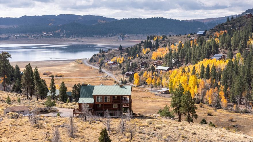 Escape to the mountains and experience true Utah serenity with this stunning cabin for sale overlooking Panguitch Lake. Perfectly situated on 1.41 acres (two combined lots: 0.77 + 0.64 acres), this Southern Utah mountain retreat offers 4 bedrooms, 3.5 baths, and a spacious, open layout designed for comfort, entertaining, and breathtaking lake and mountain views. The main level features two bedrooms, a full bath, a cozy stone fireplace, and a theater room that can double as a sleep space for kids or guests. A laundry/kitchenette area adds convenience and functionality. Upstairs, the open-concept great room showcases vaulted ceilings, massive windows, and a grand stone wood-burning fireplace — creating the perfect gathering space after a day on the lake. The gourmet kitchen includes double wall ovens, ample counter seating, and a large dining area, ideal for hosting family and friends. The primary suite captures panoramic views of Panguitch Lake and features a two-sided gas fireplace shared with the luxurious ensuite boasting a jetted tub and walk-in shower. A half bath completes this level. The loft level offers a private bedroom with a stone fireplace and a full bath with a beautiful stone shower. This space also doubles as a game room complete with shuffleboard, dart board, pool/ping pong table, card table, and a wet bar-perfect for entertaining year-round. Step outside to enjoy expansive decks with both covered and open areas ideal for relaxing, barbecuing, or entertaining. Gather around the outdoor fire pit area under the stars and roast marshmallows. A storage shed provides extra space for lake gear, ATVs, or mountain equipment. With its warm tongue-and-groove wood finishes, this Panguitch Lake cabin delivers the ideal balance of rustic charm and modern luxury  just minutes from world-class fishing, boating, and outdoor recreation.