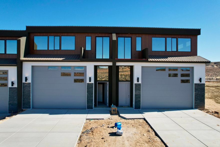 YOUR LAKE POWELL ADVENTURE HEADQUARTERS! Units are offered as a blank canvas ready to finish to your taste. Each features 1,637 sq. ft. of garage/storage (14x16 door, 55 ft deep) — perfect for boats, RVs, and toys — plus 1,358 sq. ft. of upper-level living space with high ceilings and a covered patio. That's nearly 3,000 sq. ft. total for your Lake Powell retreat or investment property. Nightly rental approved — imagine storing your boat and having your upper level pay for it!