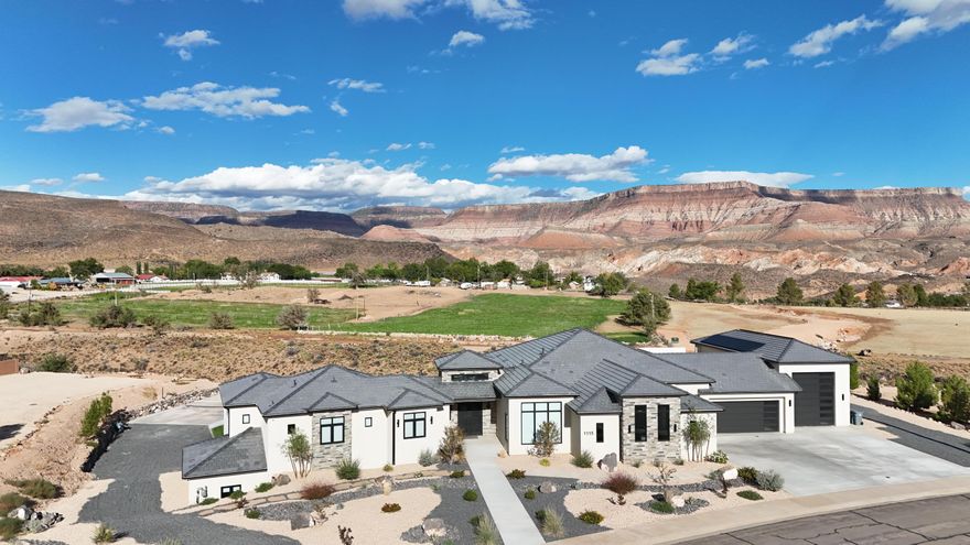 Discover this one-of-a-kind custom home in Toquerville, perfectly blending modern luxury with resort-style living. Spanning **5,449 sq. ft.**, this residence offers **5 bedrooms, 6.5 bathrooms**, Dedicated office with views, Large gym with shower, cold plunge, wired for a sauna and the continuous views of mountains. This home has every amenity designed for comfort, entertainment, and lifestyle.*

Step inside to find *soaring storefront windows**, **engineered hardwood flooring*, and *high-end finishes* throughout. The chef's kitchen features *Thermador appliances, column fridge/freezer extra wide**,  12ft custom  kitchen cabinetry, gorgeous quartzite countertops, beautiful long wood beams expanding throughout home and an open layout ideal for gathering. Whole home SONOS Sound System including the patio and pool areas.
The expansive 2,360 sq.ft. 8 car car garage and 50' RV garage provides unmatched storage for toys, cars, and gear, while the oversized yard sets the stage for outdoor living. Enjoy unobstructed views of the surrounding landscape and the breathtaking Zion National Park mountains from your rooftop patio.

Home is equipped with full solar panel system, with backup batteries.  All the Hvac systems are heat pumps as well as the pool heater that are 300% more efficient than your standard central systems.

The backyard is truly a showpiece, complete with a 40' pool and spa, swim-up bar stools, poolside bar, and jumping rocks for endless fun. Challenge friends on your own pickleball and basketball court, then relax and take in the views.

This property is more than a home  it's a destination. Designed with entertainment, relaxation, and luxury in mind, it offers an unparalleled Southern Utah lifestyle.

Seller Financing is available, call/text for details